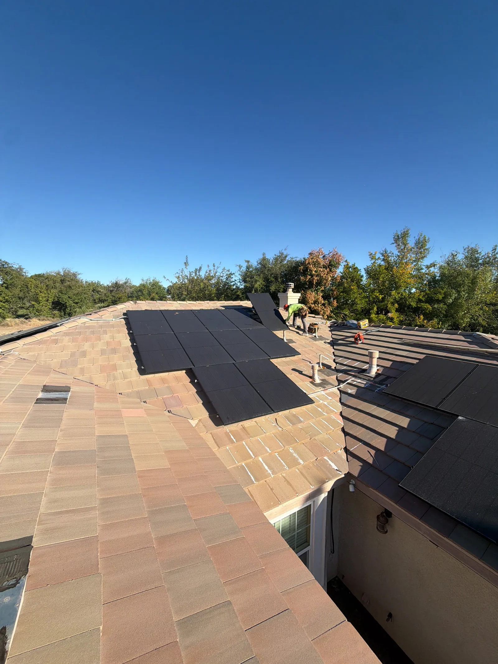 Concrete tile relaid around a home's existing solar panels